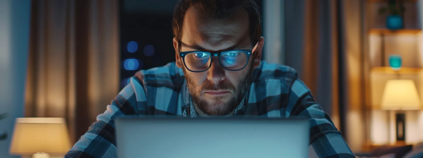 potential renter looking puzzled at a laptop screen while browsing apartment listings online.