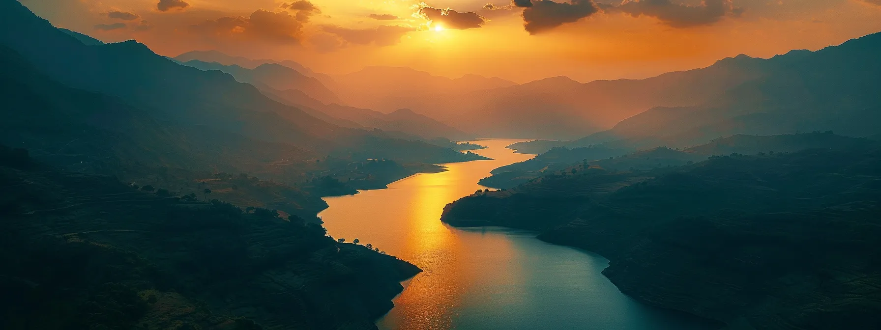 a breathtaking sunset casts vibrant hues across a tranquil lake, with silhouetted mountains framing the horizon, embodying serenity and natural beauty.