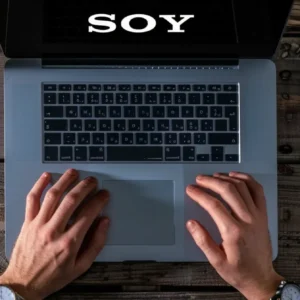 a person using a laptop surrounded by various seo tools on the screen.