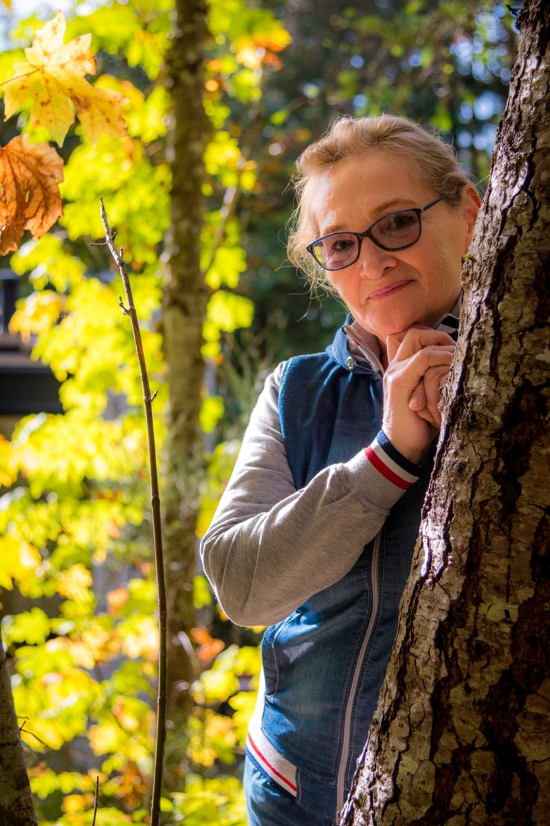 a person leaning against a tree