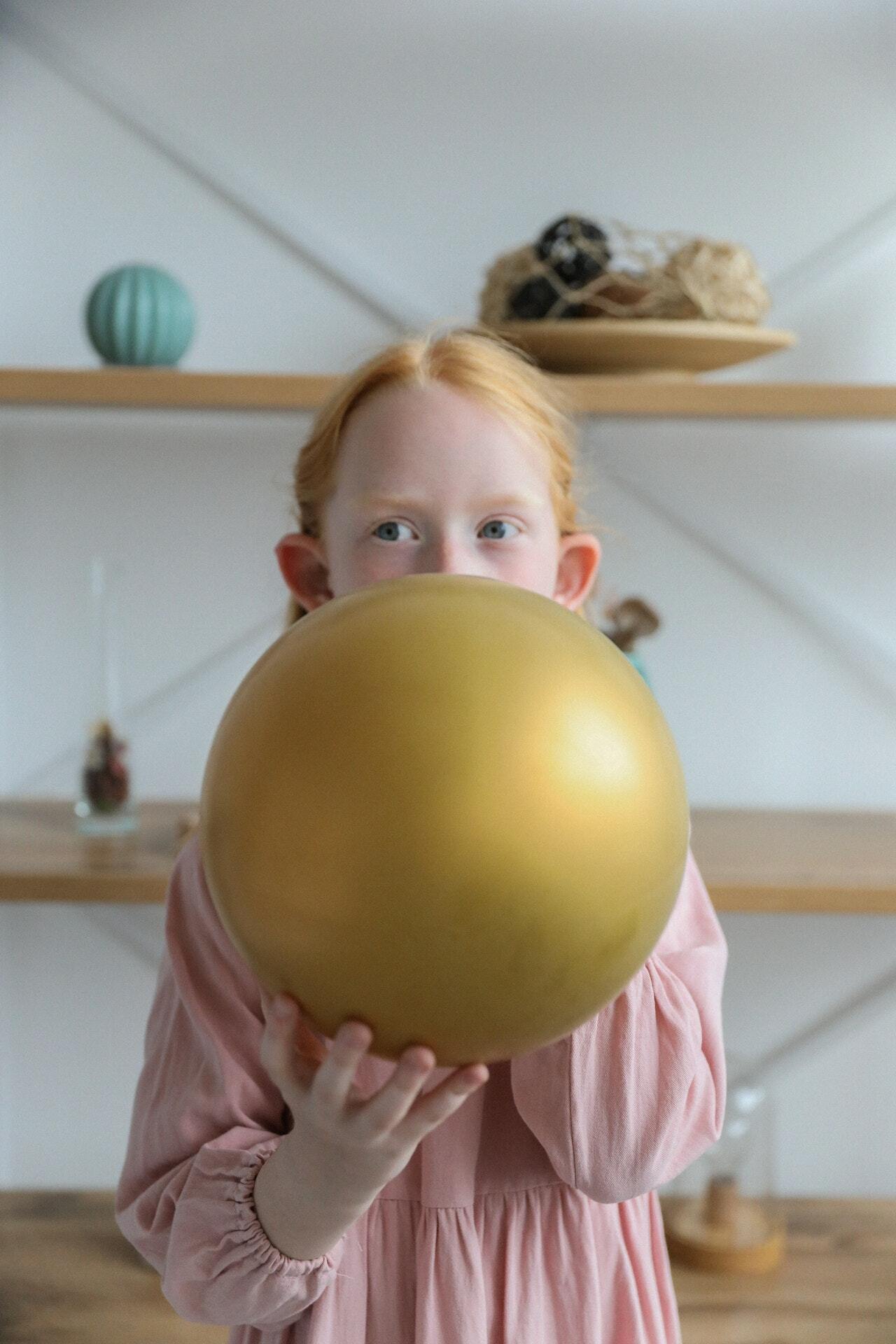 a child holding a large yellow apple