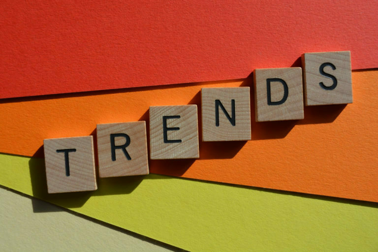 Trends, word in 3D wooden alphabet letters isolated on colourful background