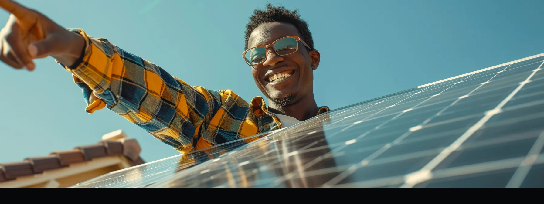 a homeowner smiling and pointing at newly installed solar panels on their roof.