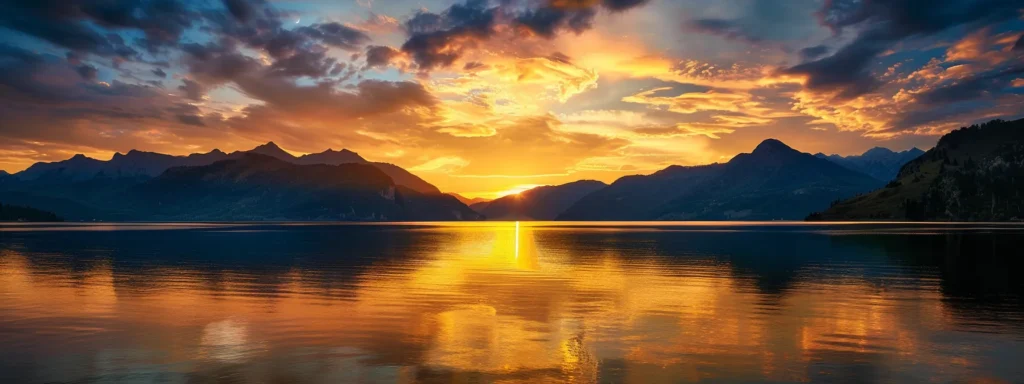 a breathtaking sunset casts golden hues over a tranquil lake, with silhouettes of majestic mountains framing the horizon and wispy clouds reflecting the vibrant colors.
